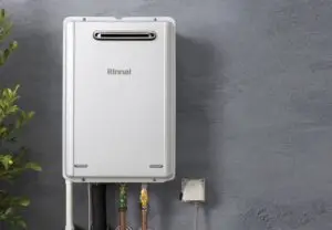 Rinnai INFINITY® EF26 external water heater installed on a grey wall.